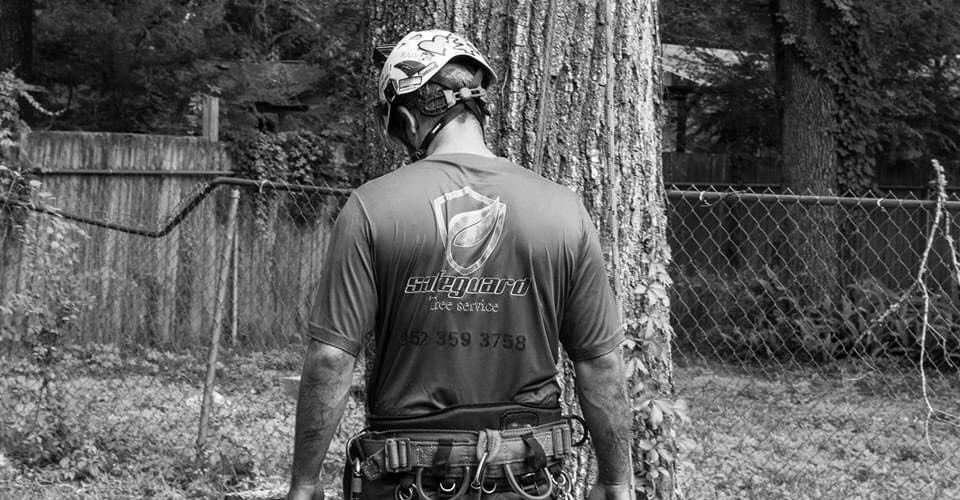 A Safeguard employee wearing a company shirt with the Safeguard logo printed on the back.